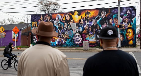 Two men in East Austin look at new mural on 12th & Chicon, Austin TX